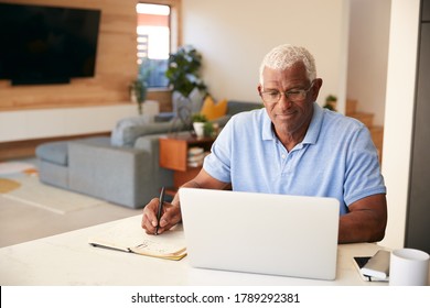 Senior African American Man Using Laptop To Check Finances At Home