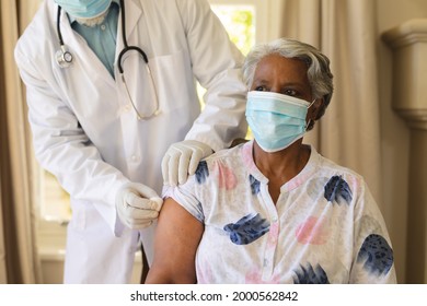 Senior African American Woman In Face Mask Receiving Vaccination. Retirement And Senior Lifestyle During Covid 19 Pandemic Concept.