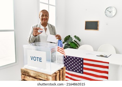 Senior African American Woman Holding I Voted Badge Voting At Electoral College