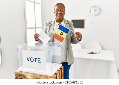 Senior african american woman holding moldova flag voting at electoral college