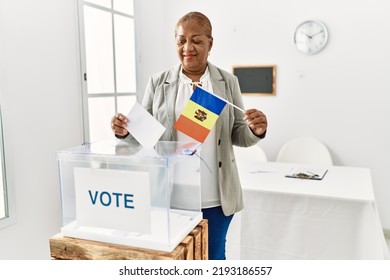 Senior African American Woman Holding Moldova Flag Voting At Electoral College