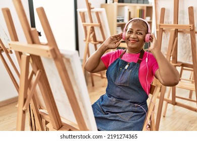 Senior African American Woman Listening To Music Drawing At Art Studio