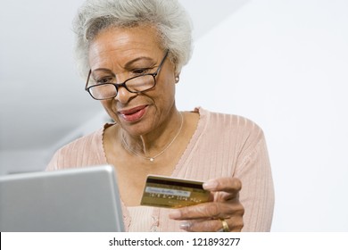 Senior African American Woman Shopping Online Using Laptop And Credit Card