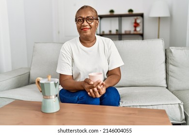 Senior African American Woman Smiling Confident Drinking Coffee At Home