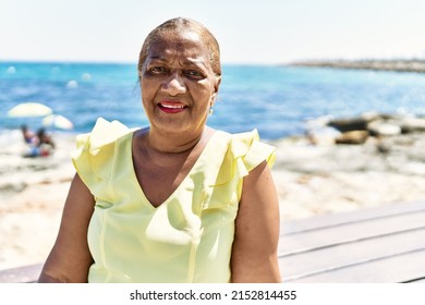 Senior African American Woman Smiling Happy Sitting On The Bench At The Beach.