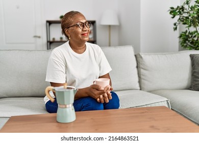 Senior African American Woman Smiling Confident Drinking Coffee At Home