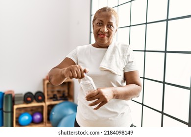 Senior African American Woman Smiling Confident Drinking Water At Sport Center