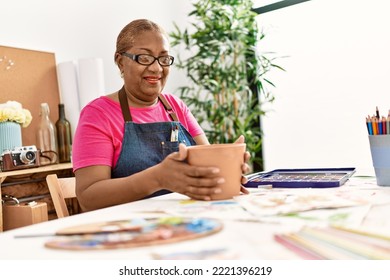 Senior African American Woman Smiling Confident Making Clay Ceramic At Art Studio