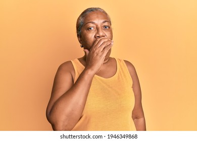 Senior african american woman wearing casual style with sleeveless shirt feeling unwell and coughing as symptom for cold or bronchitis. health care concept.  - Powered by Shutterstock