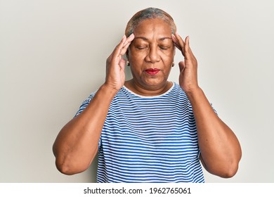 Senior african american woman wearing casual clothes with hand on head, headache because stress. suffering migraine. 