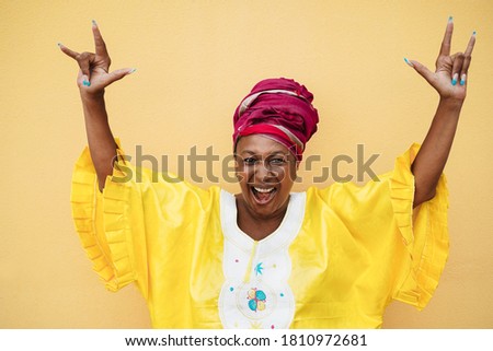 Senior african woman dancing outdoor - Focus on face