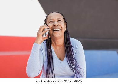 Senior African Woman Having Fun On A Call With Mobile Phone Outdoor