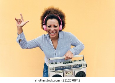 Senior African Woman Listening Music In Boombox Vintage Stereo - Focus On Face