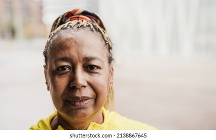 Senior african woman looking at camera outdoor - Focus on face