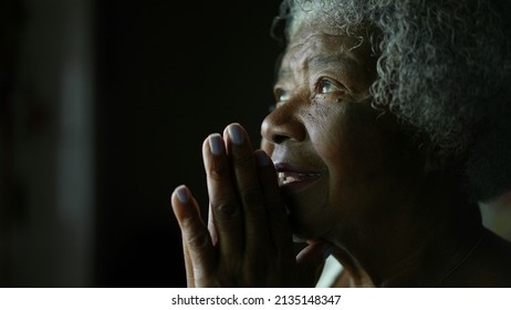 A senior African woman praying to God in meditation - Powered by Shutterstock