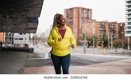 senior african woman running outdoor - Focus on face - Powered by Shutterstock