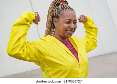 Senior African Woman Showing Biceps Muscle During Sport Workout In The City