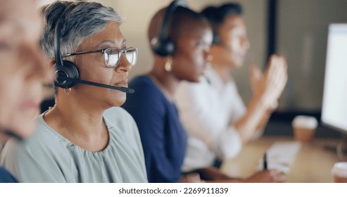 Senior agent face, call center and woman on phone call with customer, contact us and CRM with communication. Customer service, telemarketing and tech support with headset and work in coworking space - Powered by Shutterstock