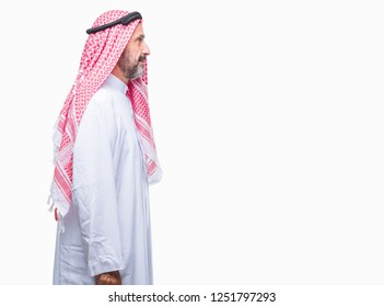 Senior Arab Man Wearing Keffiyeh Over Isolated Background Looking To Side, Relax Profile Pose With Natural Face With Confident Smile.