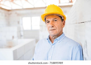 Senior architect or civil engineer on the construction site.