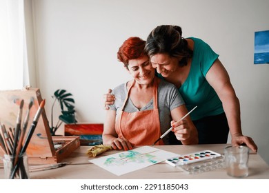 Senior artist gay couple couple painting at art gallery school - Lesbian family, LGBTQ concept - Powered by Shutterstock