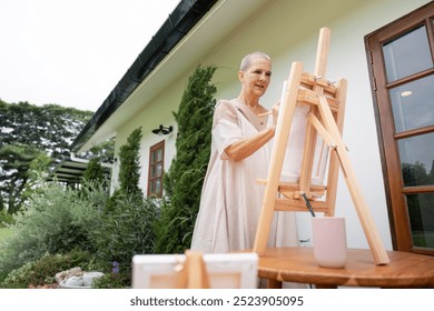 Senior Artist Planning Her Outdoor Painting Session - Powered by Shutterstock