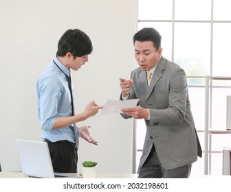 Senior Asain Businessman Boss Feel Unhappy With Serious Face And Argue With Young Junior Employee. Daily Problem From Working In Office Concept.