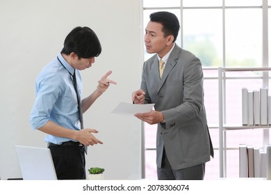 Senior Asain Businessman Boss Feel Unhappy With Serious Face And Argue With Young Junior Employee. Daily Problem From Working In Office Concept.