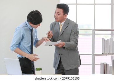 Senior Asain Businessman Boss Feel Unhappy With Serious Face And Argue With Young Junior Employee. Daily Problem From Working In Office Concept.