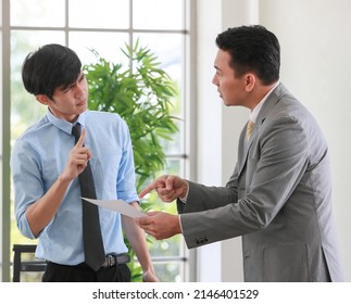 Senior Asain Businessman Boss Feels Angry And Unhappy With Serious Face And Argue With Young Junior Employee. Daily Problem From Working In Office Concept.