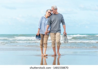 Senior Asia Couple Running Along Winter Beach