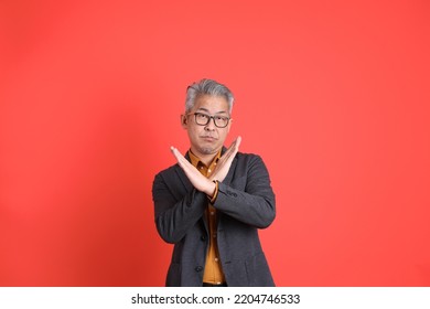 The Senior Asian Business Man Standing On The Ornage Background.