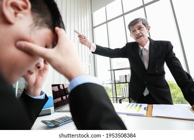 Senior Asian businessman with mustache leader standing, shouting and firing unprofessional male office workers out of company from poor performance and bad working. Concept of unemployment