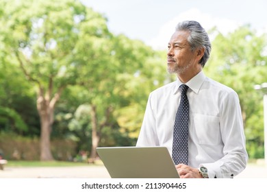 Senior Asian Businessman Using Laptop