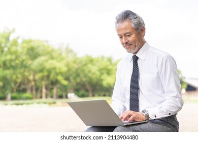 Senior Asian Businessman Using Laptop