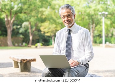 Senior Asian Businessman Using Laptop