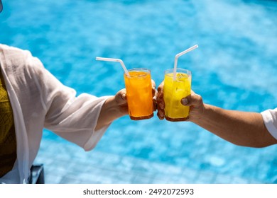 Senior Asian couple got refreshment fruit juice by the swimming pool in the tropical resort hotel for summer vacation travel and happy retirement elder for healthy aging activity wellness - Powered by Shutterstock