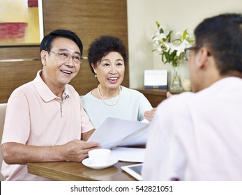 senior asian couple listen to explanation by a sales representative, happy and smiling.