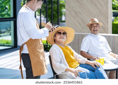 Senior Asian couple ordering food by the tropical swimming pool in the resort hotel for summer vacation travel and happy retirement elder, second honeymoon, healthy aging activity wellness - Powered by Shutterstock