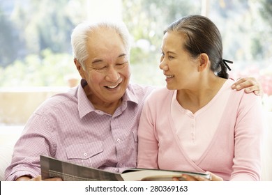 Senior Asian Couple Reading Magazine