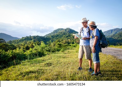 Senior Asian Couple Trekking, traveling, living a happy life in retirement Healthy, can see the fresh nature. The concept of health tourism for the elderly. with copy space. - Powered by Shutterstock