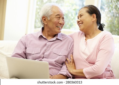 Senior Asian Couple Using Laptop