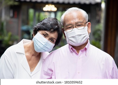 senior asian couple wearing face mask or face covering, concept social distancing, new normal lifestyle, protective health care