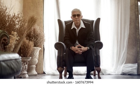Senior Asian Elder Mafia Man Handsome And Suit Sitting In Rich Expensive House