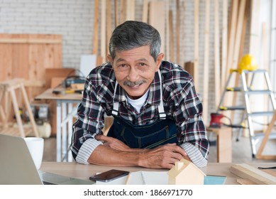 Senior Asian Elderly Old Man Carpenter Using Laptop To Study And Search Building Idea For Build Diy Furniture In Workshop