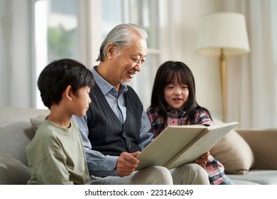 senior asian grandfather having a good time with two grandchildren at home - Powered by Shutterstock