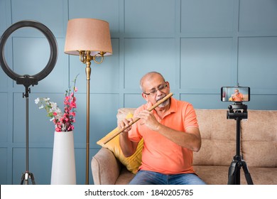 Senior Asian Indian Musician Performing While Taking Online Music Class Or Recording Video On Smartphone