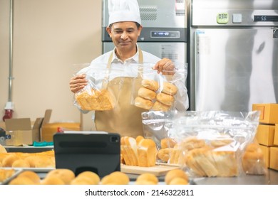 Senior Asian Male Chef In Apron, Small Business Blogger Live Streaming Via Mobile Application Technology, Bakery Sales Online Promotion, Fresh Bread.