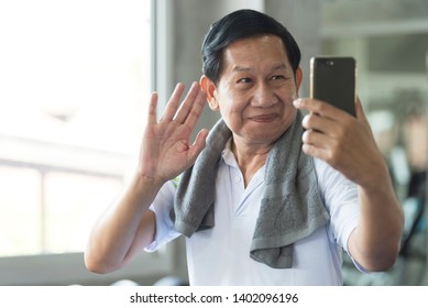 Senior Asian Man Attractive Smiling Active Fitness In Gym And Taking A Selfie.