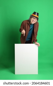 The Senior Asian Man Dressing In Thanksgiving Season Color Theme, Wearing Orange Plaid Shirt And Black Hat Standing On The Green Background.